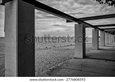Columns and Crossbeams on an Empty Ocean and Beach.