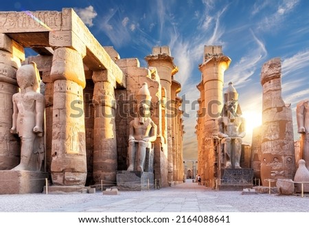 Columns and statues of the Luxor temple main entrance, first pylon, Egypt