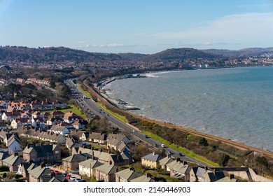 Colwyn Bay North Wales UK March 2022 Looking Down From Above Over The Town And Roof Tops Of House With The A55 By Pass Running Along Side The Sea Shore And Beach