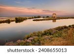 Comacchio, Ferrara, Emilia Romagna, Italy: sunset landscape of the swamp in the Po Delta Park nature reserve 

