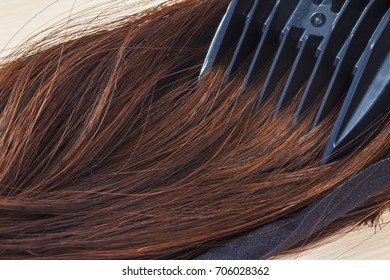 Comb combing brown hair - Shutterstock ID 706028362