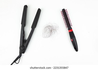 Comb and hair straightener Electric curling iron with ceramic plates and black hair loss on a white background. Straight hair - Shutterstock ID 2231355847