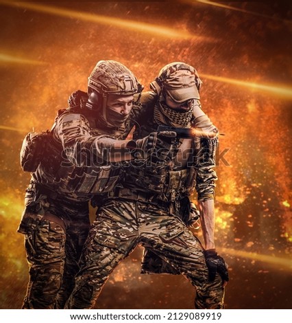 Combat conflict, special mission. The military soldier carrying teammate out of the battlefield. Studio photo against a dark wall