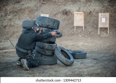 Combat gun shooting training from behind and around cover or barricade. Advanced fighting tactical shooting courses on shooting range