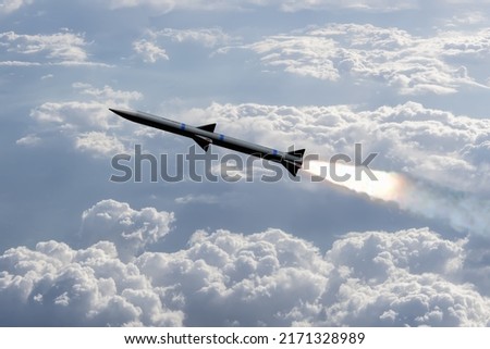 A combat rocket is flying above the clouds, smoke and fire from the rocket. Concept: missile attack, air attack, war between Russia and Ukraine, missile strike.