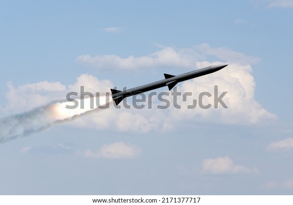 A combat rocket is flying above the clouds,\
smoke and fire from the rocket. Concept: missile attack, air\
attack, war between Russia and\
Ukraine.