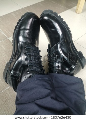 Black​ Combat Shoes Being worn by the police.
