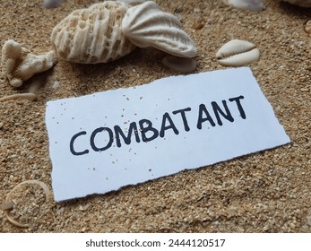 Combatant writting on beach sand background. - Powered by Shutterstock