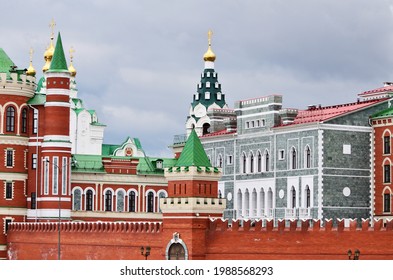 A combination of architectural styles is a grey stone building and a red brick wall. Russia Yoshkar-Ola 01.05.2021. High quality photo