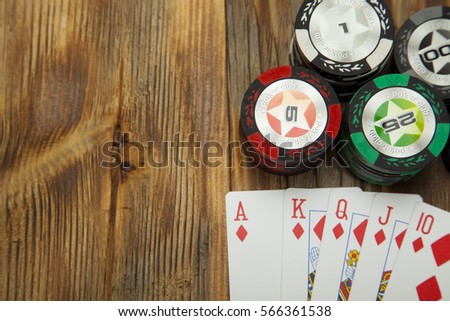 The combination of card game poker on the old wooden table