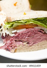 Combination Deli Sandwich Corned Beef Tongue Chopped Liver On Rye Bread With Lettuce Tomato Onion And Pickles At Kosher Delicatessen