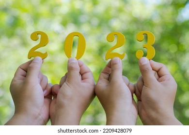 Combination Of Hands Wooden Handle Numbers 2023 On Green Background. Enviromental Sustainability Target. Goals,plan,opportunity, New Green Business And Social.