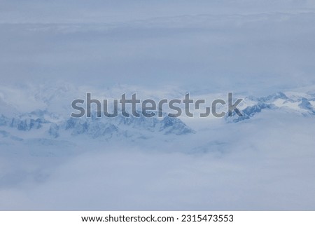 Combination of high altitude snow clouds forms picturesque scenery in Greenland mountain peaks
