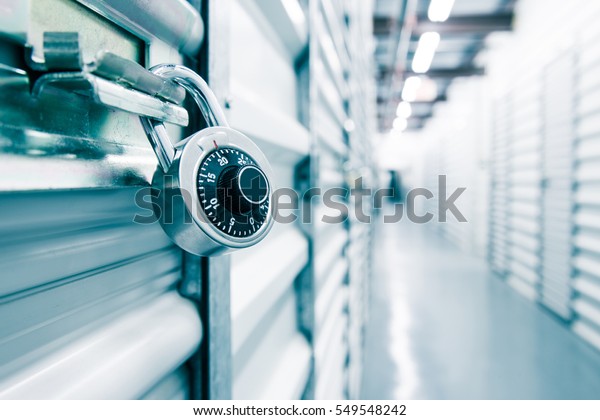 Combination lock on a self storage\
door. Life style, storage, moving, storing, organizing\
concept.