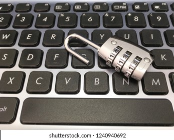 Combination padlock over computer keyboard for security concept. Copy Space.