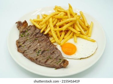 Combination plate of beef steak with potatoes and fried egg
				
