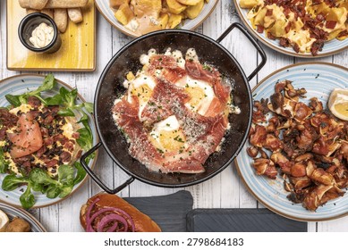 A combination plate with broken eggs, ham, and a small grilled beef steak, for a more complete meal with extra protein