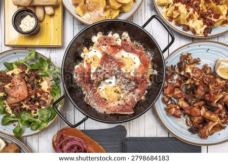A combination plate with broken eggs, ham, and a small grilled beef steak, for a more complete meal with extra protein