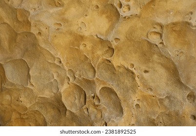 Combination of stone relief like a orange planet surface. Brown stone with abnormal relief shape with specific light