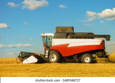 Combine Harvester In The Field During The Harvest. Side View.