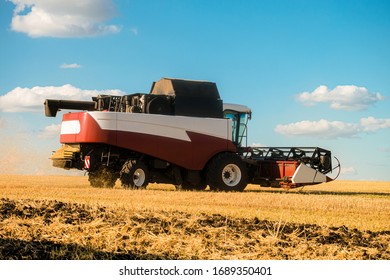 Combine Harvester In The Field During The Harvest. Side View.