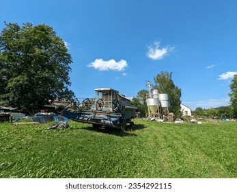 combine harvester Fortschritt E 512 panorama of czech small agriculture farm during harvest time with old harvestor in the yeallow fields in Vysocina region,Czech republic,Europe
				