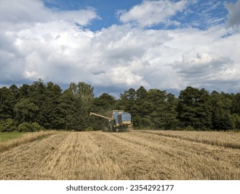 combine harvester Fortschritt E 512 panorama of czech small agriculture farm during harvest time with old harvestor in the yeallow fields in Vysocina region,Czech republic,Europe
					