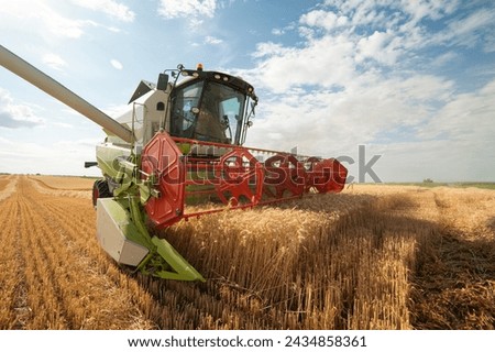 Similar – Image, Stock Photo Grain harvest. Combine harvester in operation on wheat field. Harvesting process. Agricultural machinery