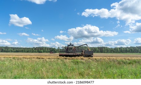 Combine Harvester Harvesting On The Field. Harvesting Wheat. Harvester Machine Working In Field. Agriculture. Large Scale Wheat Harvest Operation.