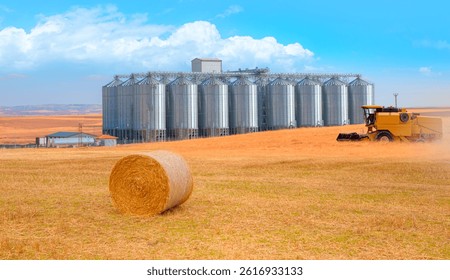 Combine harvester harvesting wheat field - Agricultural Silos for storage and drying of grains, wheat, corn, soy, sunflower