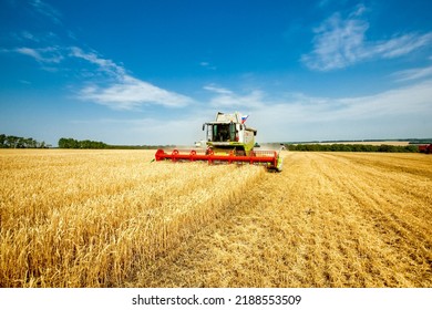 Combine harvester harvests wheat in the field. Agriculture background. Harvest season - Shutterstock ID 2188553509