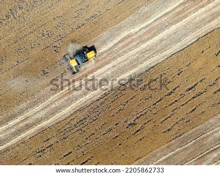 Similar – Combine harvester harvests a grain field in the evening light from the air