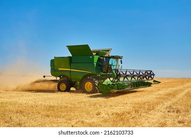 Combine harvester working on a wheat field. Seasonal harvesting the wheat. Agriculture.