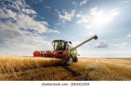 A combine harvester working in a wheat field - Shutterstock ID 2001411959