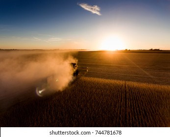 Combine at nightfall cutting corn in a field in midwest United States - Shutterstock ID 744781678