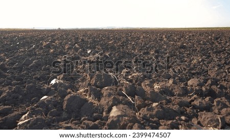 combines plowed field. modern farming and irrigation business concept. fresh arable land after lifestyle the tractor before sowing. clods of dirty ground on a plowed field close-up