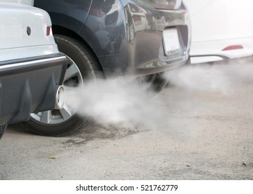 Combustion Fumes Coming Out Of Car Exhaust Pipe