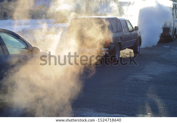 Combustion fumes coming out of\
car exhaust pipe, exhaust gas from a car with diesel or gasoline\
engine