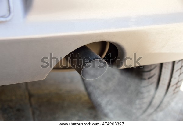 combustion fumes coming\
out of car exhaust pipe as concept of damage in the climate change\
and global warming