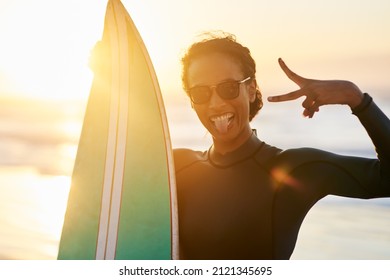 Come get your surf on. Portrait of a beautiful young female surfer posing with her surfboard at the beach. - Powered by Shutterstock