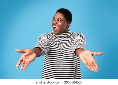 Come Here. Excited Overweight African American Woman Shouting Stretching Hands Looking At Camera Posing Over Blue Background In Studio. Give Me A Hug Concept - Powered by Shutterstock