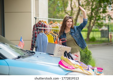 Come Here. Nice Positive Woman Waving With Her Hand While Inviting Her Neighbors To The Garage Sale