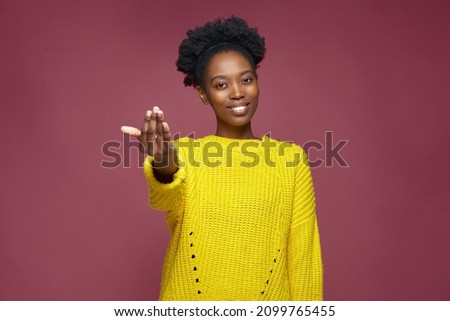 Come here. Toothy smiling young african american girl calling with beckoning gesture, inviting, looking at camera Stock photo © 