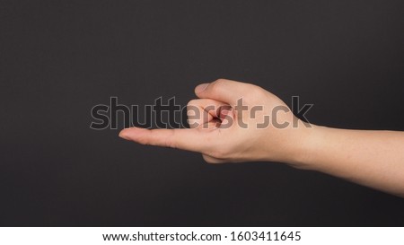 The Come Hither Hand Sign on black background.Use it when you want someone to come over.
 Stock photo © 
