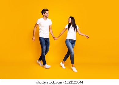 Come with me honey! Full body photo of two people walking down street for shopping wear casual clothes isolated yellow color background