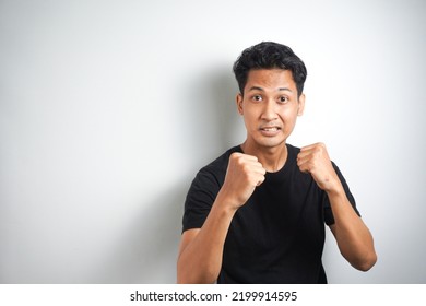 Come On Let Us Fight. Portrait Of Excited Self-assured Arrogant Male Model, Raising Fists And Standing In Boxer Pose, Wanting To Punch Someone While Drunk At Pub Over White Wall