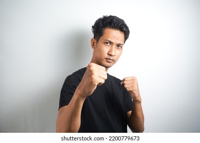 Come On Let Us Fight. Portrait Of Excited Self-assured Arrogant Male Model, Raising Fists And Standing In Boxer Pose, Wanting To Punch Someone While Drunk At Pub Over White Wall