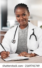 Come See Me For A Clean Bill Of Health. Shot Of A Young Doctor Making Notes At Her Desk.