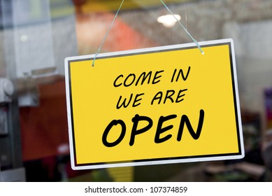 Come In We Are Open Sign Hanging On A Window Door Outside A Restaurant, Store, Office Or Other