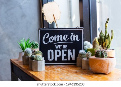 Come in we're open, vintage black retro sign in cafe - Powered by Shutterstock